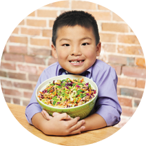 image:A boy holding a bowl of salad